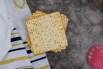Tradition of Jewish people with Matzah, Passover unleavened bread, kippah, tallit are symbols of...