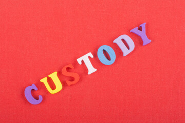 Fototapeta na wymiar CUSTODY word on red background composed from colorful abc alphabet block wooden letters, copy space for ad text. Learning english concept.