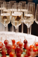 Buffet, glasses of champagne, sparkling wine, sparkling in the sun. Catering, party service. Festive event, welcome drink