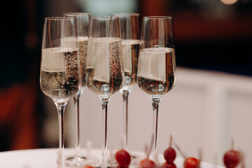 Buffet, glasses of champagne, sparkling wine, sparkling in the sun. Catering, party service. Festive event, welcome drink