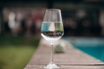 A small tasting glass of sparkling champagne. An unfinished glass of alcohol. Drink champagne or a cocktail. A dirty glass