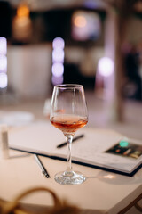 A small tasting glass of sparkling champagne. An unfinished glass of alcohol. Drink champagne or a cocktail. A dirty glass