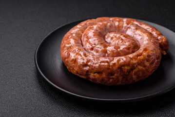 Delicious grilled sausage in the form of a ring with salt, spices and herbs