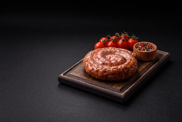 Delicious grilled sausage in the form of a ring with salt, spices and herbs