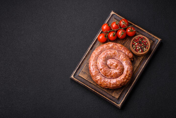 Delicious grilled sausage in the form of a ring with salt, spices and herbs