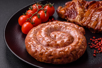 Delicious grilled sausage in the form of a ring with salt, spices and herbs