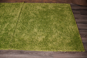 Vibrant green artificial grass rug, perfect for indoor or outdoor decor.