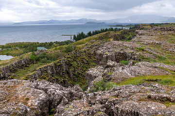 Fototapeta na wymiar Panoramic view over the seismic rift valley between the Eurasian and North American tectonic plates in Pingvellir National Park, Iceland with Pingvallavatn lake in background