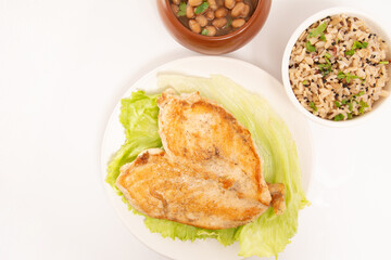 Grilled chicken in a plate with salad and rice isolated clean white background top view photo