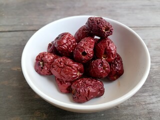 Dried jujube fruit on wood background