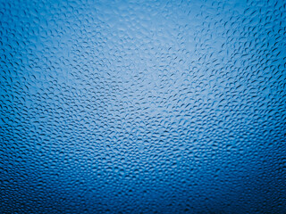 Fine raindrops on the car glass after waxing.