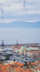 View from the top of the beautiful croatian city of Rijeka on a stormy day and with the mountains...