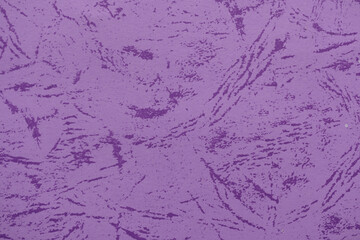 A vibrant purple wall featuring a rough, textured pattern, ideal for backgrounds or graphic elements.