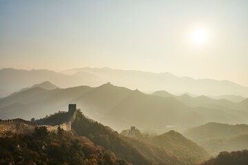 At the break of dawn, the majestic expanse of the Great Wall of China emerges, stretching endlessly...