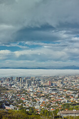 Clouds, sky and top view of city and buildings in landscape, travel destination with skyscraper and outdoor. Urban development, architecture and environment for tourism with adventure and location