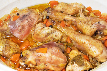 Chicken meat baked in the oven with chopped onions and carrots. Ready-to-eat poultry meal with vegetables