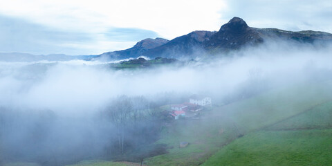 Aerial drone view of the winter landscape around the town of Gainza and Amezqueta and the Txindoki Mountain. Aralar Mountain Range. Goierri region. Gipuzkoa. Basque Country. Spain. Europe
