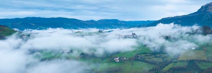Aerial drone view of the winter landscape around the town of Gainza and Amezqueta and the Txindoki Mountain. Aralar Mountain Range. Goierri region. Gipuzkoa. Basque Country. Spain. Europe