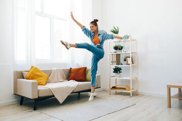 Joyful Woman Jumping with Music in a Happy, Playful Concept: Relaxation and Carefree Lifestyle at Home