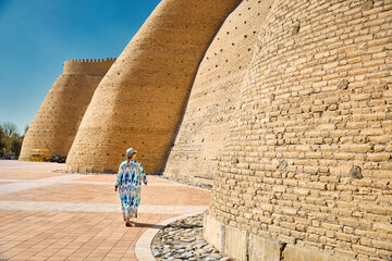 Tourist near Walls of the Ark of Bukhara in Uzbekistan.