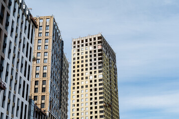 Fototapeta premium Skyscrapers rise high against a clear blue sky in urban design