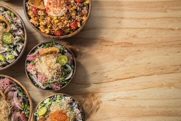 Hawaiian food in bowls on wooden table. Top view with copy space