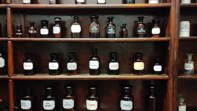 Vintage shelves with antique bottles of medicine or alcohol. An ancient pharmacy, bar or alchemy workshop.
