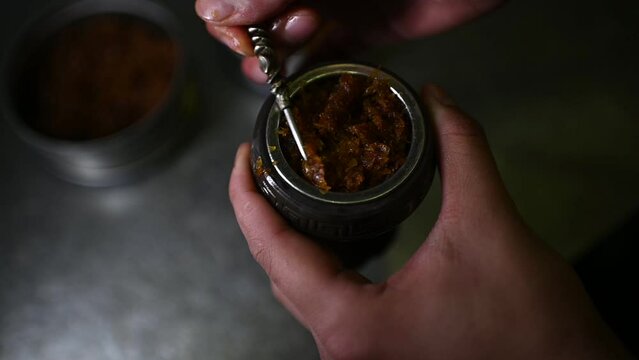 Preparing a bowl with tobacco for hookah.