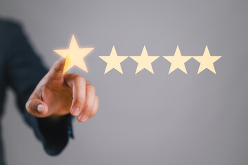 Hand of businessman touching five star symbol to increase rating of company concept, Copy space...