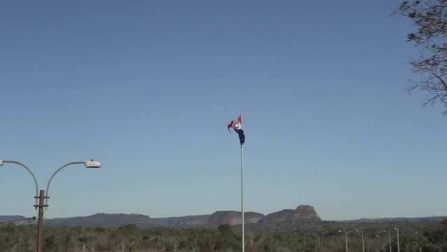 National flag of Paraguay waving in the wind at Cerro Cora national park.
