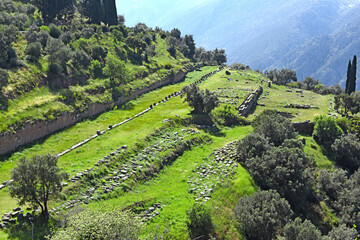 view to the ruins and the sacred way leading to the treasury of the Athenians in Archaeological Site of Delphi, Greece
