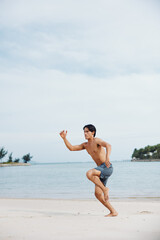 Muscular Asian Man Enjoying Beach Running - Exhilarating Fitness on Sand