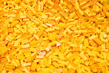 Naklejka premium Billund, Denmark - 17 June 2023: Yellow plastic Lego brick background