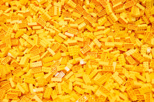 Billund, Denmark - 17 June 2023: Yellow plastic Lego brick background