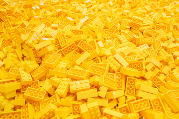 Obraz premium Billund, Denmark - 17 June 2023: Yellow plastic Lego brick background