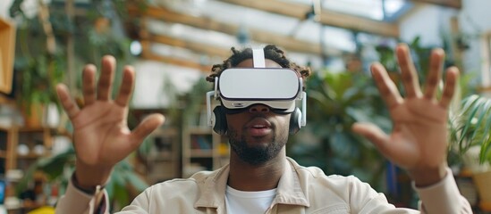 An African American man is immersing himself in virtual reality while standing in a lush greenhouse environment.