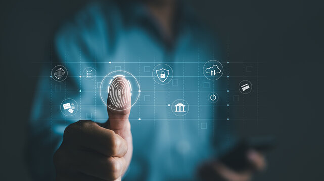 Cyber security concept. Businessman using thumb to scan fingerprint or for digital processing biometric identification to access security system including Internet banking, Cloud computing, Big data,