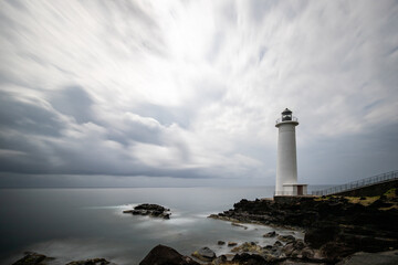 Le Phare du Vieux-Fort, white lighthouse on a cliff. Dramatic clouds overlooking the sea. Pure...