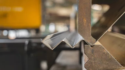 Foto op Plexiglas Metal stainless sheet bending on hydraulic machine.  bending stainless sheet.  © Kritsana