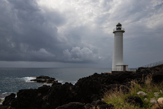 Le Phare du Vieux-Fort, white lighthouse on a cliff. Dramatic clouds overlooking the sea. Pure Caribbean on Guadeloupe, French Antilles, France