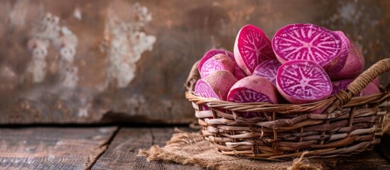 Obraz na płótnie Canvas A basket filled with purple colored eggs is placed on top of a textured wooden table. The vibrant eggs contrast beautifully against the rustic backdrop, creating a simple yet visually striking scene.