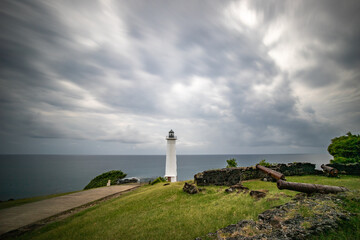 Le Phare du Vieux-Fort, white lighthouse on a cliff. Dramatic clouds overlooking the sea. Pure Caribbean on Guadeloupe, French Antilles, France - obrazy, fototapety, plakaty
