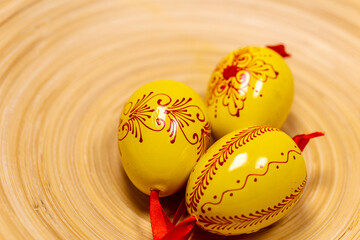 Easter eggs on a bamboo tray.