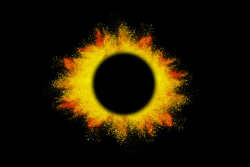 Explosion of colored orange powder with empty space circle for text, isolated on black background