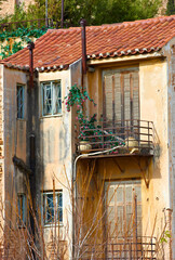 Fototapeta na wymiar Village, architecture and abandoned house with balcony in Athens for heritage, culture and tradition. Building, property and ancient residential community or neighborhood in ghost town and historic