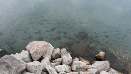Lake shore dotted with rocks