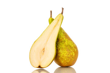 One whole and one half green pear, macro, isolated on white background.