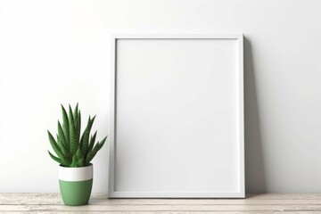 White empty vintage wooden picture frame hangs on a textured interior wall for a touch of architectural decoration with green plants close white wall. Frame mockup, 3d poster mockup  - obrazy, fototapety, plakaty