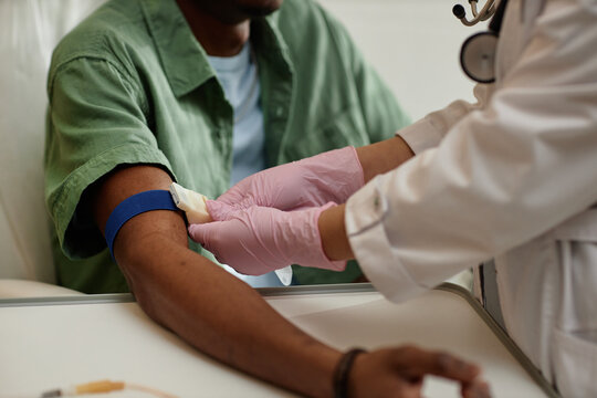 Close up nurse preparing patient for blood test and putting tourniquet on arm in procedure room at clinic copy space