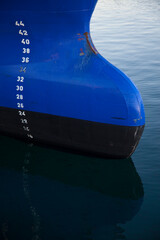 Blue fishing vessel detail, waterline (the sea full of tiny fish), Tromso, Norway